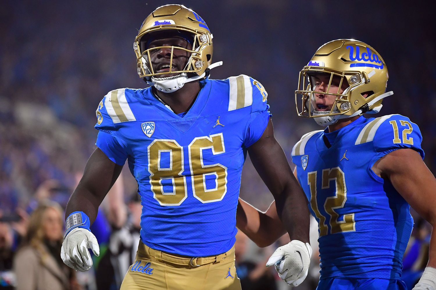 Nov 19, 2022; Pasadena, California, USA; UCLA Bruins tight end Michael Ezeike (86) celebrates his touchdown scored against the Southern California Trojans with wide receiver Matt Sykes (12) during the second half at the Rose Bowl. Mandatory Credit: Gary A. Vasquez-USA TODAY Sports  